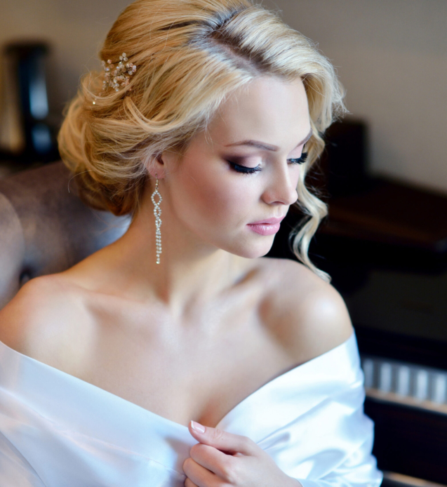 Beauty bride in dressing gown with bridal makeup indoors. Beautiful model girl in colorful wedding robe. Female portrait of cute lady. Woman with hairstyle