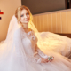 Beautiful bride in white wedding dress on wedding day. A woman is waiting for her fiancé before the wedding ceremony. Girl with a veil on her head