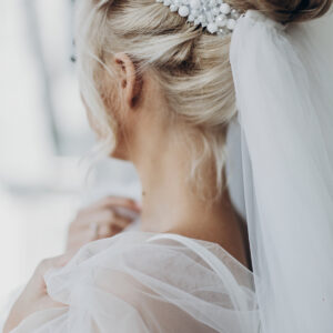 luxury beautiful bride hair style with pearl and veil, back view. stylish hairstyle, modern bride. wedding day, preparation in the morning. romantic moment. space for text