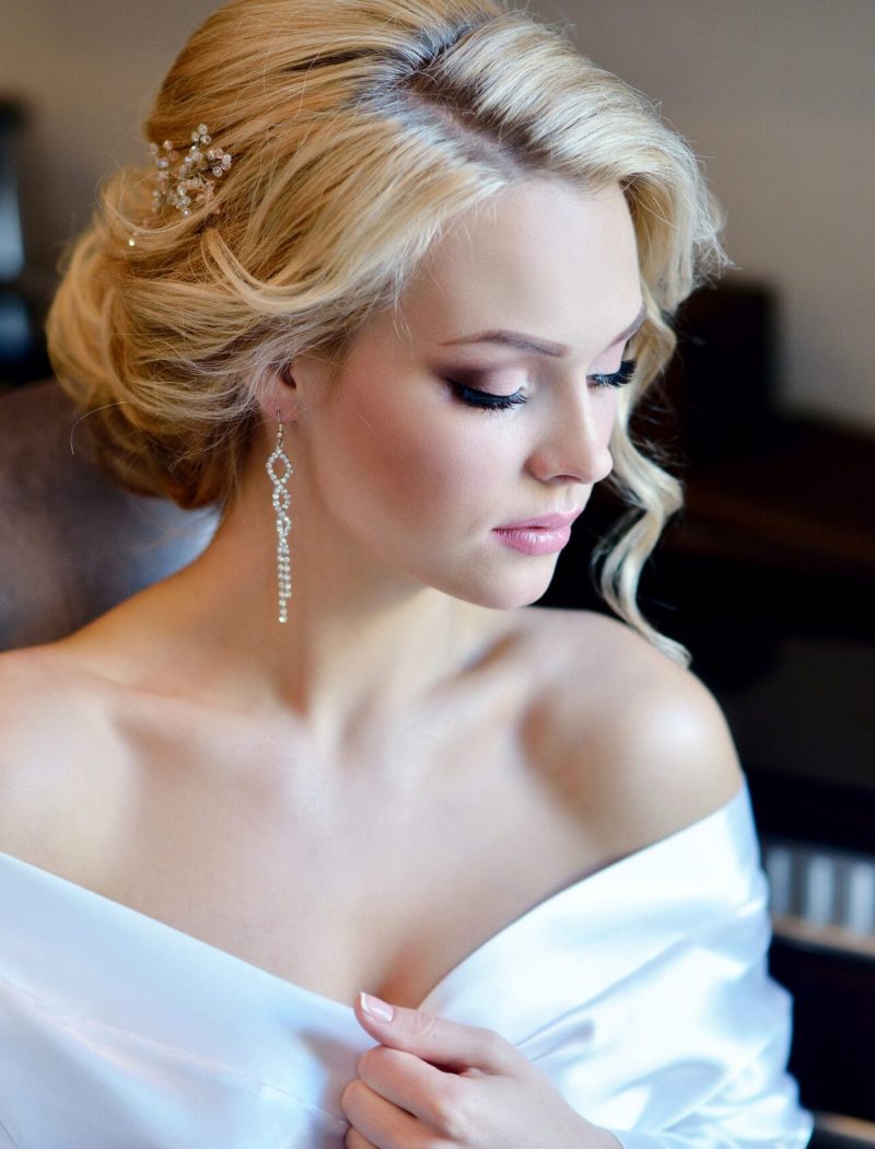 Beauty bride in dressing gown with bridal makeup indoors. Beautiful model girl in colorful wedding robe. Female portrait of cute lady. Woman with hairstyle