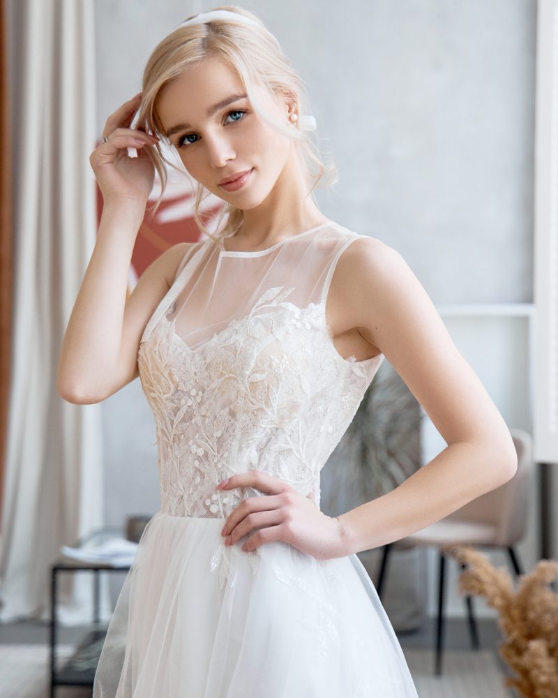 Blonde girl in a beautiful white wedding dress. A woman bride is waiting for the groom before the wedding