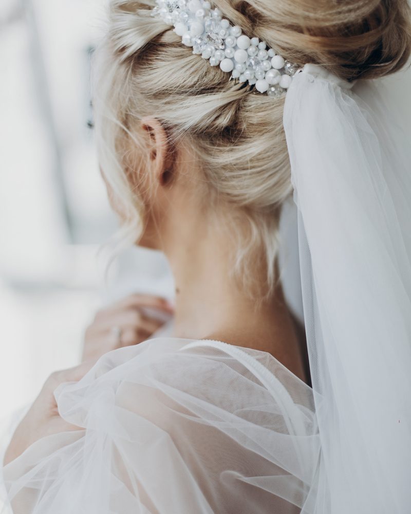 luxury beautiful bride hair style with pearl and veil, back view. stylish hairstyle, modern bride. wedding day, preparation in the morning. romantic moment. space for text